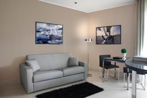 a living room with a couch and a table at Riva Del Sole Resort & SPA in Castiglione della Pescaia