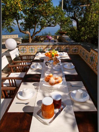 a long table with plates of food on it at Antonio Massa Lubrense in Massa Lubrense