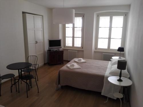 a bedroom with a bed and a table and chairs at Palazzo Brigido in Trieste