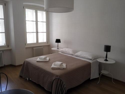 a bedroom with a bed with two towels on it at Palazzo Brigido in Trieste