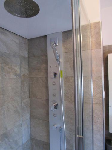 a shower with a glass door in a bathroom at Casa Balducci Bed&Breakfast in Mercatello sul Metauro