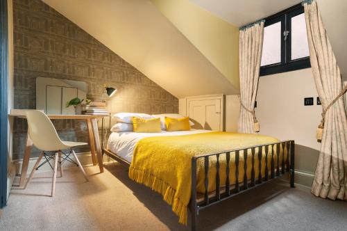 a bedroom with a bed and a desk with a chair at No11 Boutique Hotel & Brasserie in Edinburgh