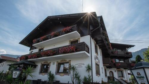 a white building with flower boxes on it at Gasthof Pension Alpenblick in Radfeld