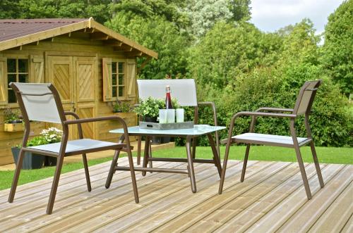 two chairs and a table on a deck at La Villa Belle in Belle-et-Houllefort