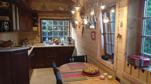 a kitchen with a table with a bowl of food on it at Domek nieopodal rzeki Bug in Klepaczew