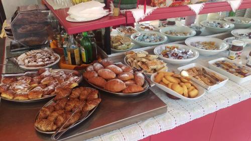 a buffet with many different types of food on a counter at Hotel Prestigio in Cesenatico