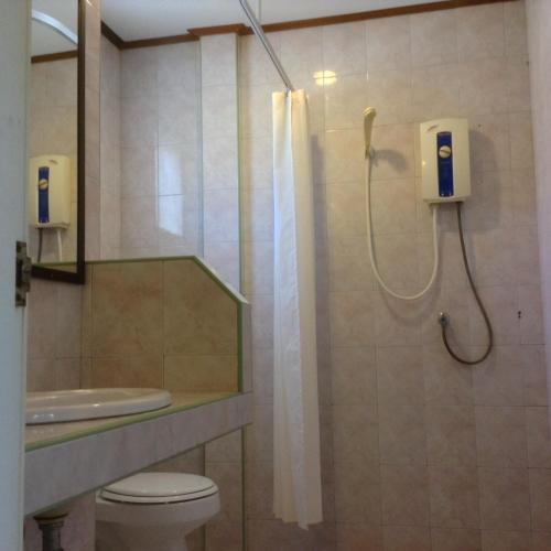 a bathroom with a shower with a toilet and a sink at Marina Beach Resort - SHA Extra Plus in Lamai