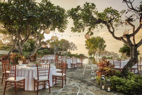 a set up for a wedding with tables and chairs at Four Seasons Resort Bali at Jimbaran Bay in Jimbaran