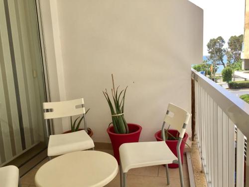two chairs and a table on a balcony at Andreas Apartment in Limassol