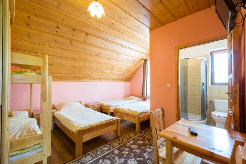 a room with two bunk beds and a toilet at Dom Wypoczynkowy Marta in Kacwin