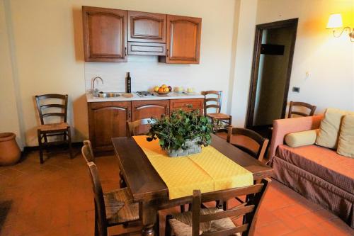 a living room with a table and a kitchen at Agriturismo Antico Borgo Poggitazzi in Loro Ciuffenna