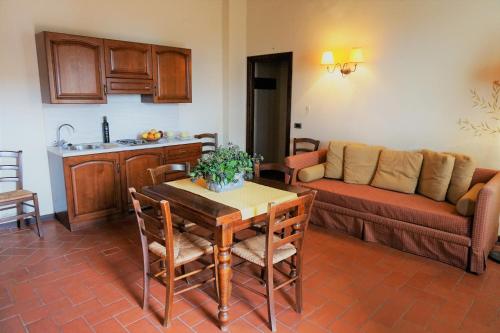 a living room with a table and a couch at Agriturismo Antico Borgo Poggitazzi in Loro Ciuffenna