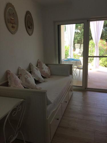 a bedroom with a bed and a sliding glass door at Apartment Marina in Silba