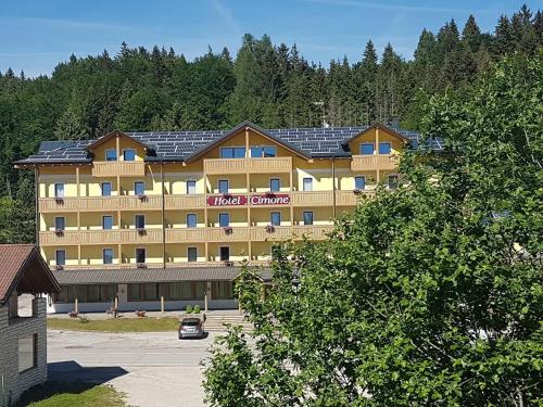 a large hotel building with solar panels on it at Caminetto Mountain Resort in Lavarone