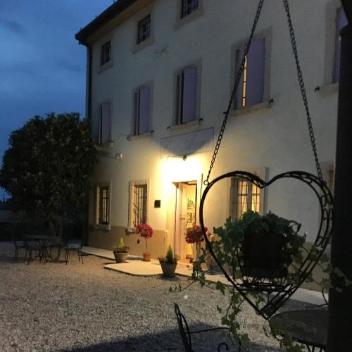 a large white building with a lit up facade at Agriturismo Casa Aurora in Bussolengo