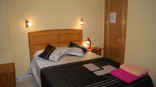 a bedroom with a bed with a laptop on it at Casa Huésped Magdalena in Madrid