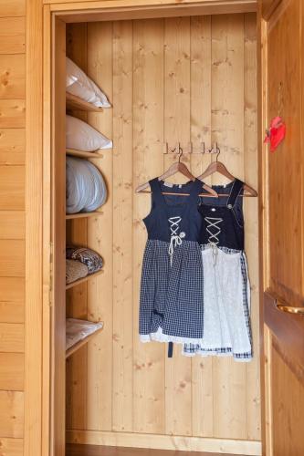 a closet with a shirt and a dress on a hanger at Albergo Diffuso Sauris in Sauris Di Sopra in Sauris