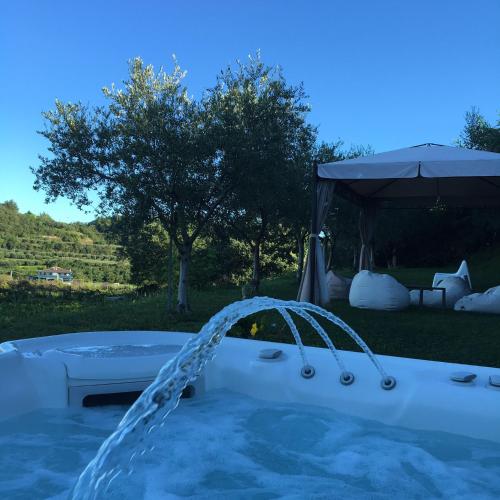 a hot tub with a gazebo in a yard at Agriturismo Casa Aurora in Bussolengo
