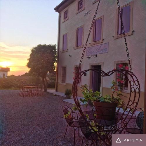 a swing in front of a white building at Agriturismo Casa Aurora in Bussolengo