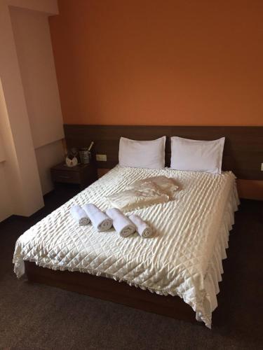 a bedroom with a bed with two towels on it at Hotel Iris in Plovdiv