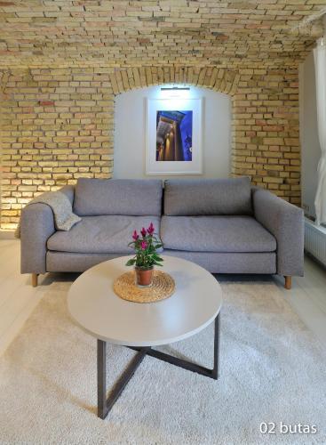 a living room with a couch and a table at Six Apartment Simona in Vilnius