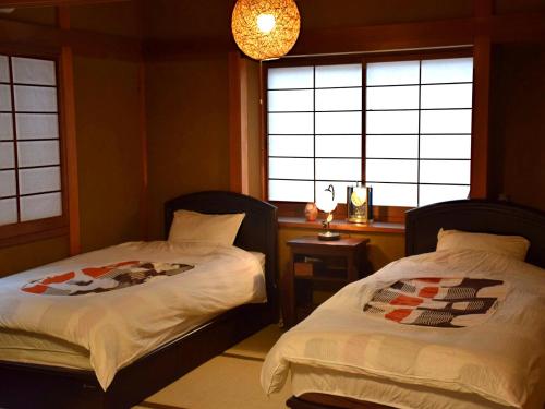 Postel nebo postele na pokoji v ubytování Guesthouse Higashiyama