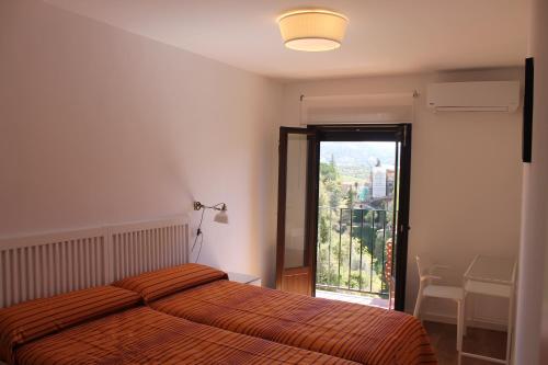 a bedroom with a bed and a large window at Buenavista Apartment in Ronda