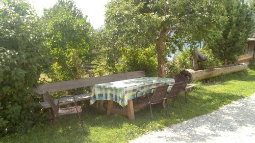 a table and chairs with a table and a bench at Karnerhof in Mariapfarr