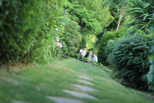 a group of people walking down a path with trees at Luccombe Hall Hotel in Shanklin