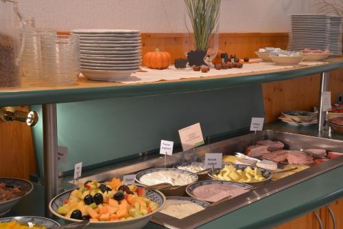 a buffet with many different types of food on display at Parkhotel zum Stern in Oberaula