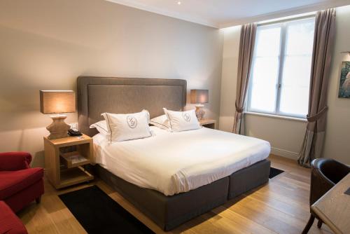 Postel nebo postele na pokoji v ubytování Hotel Le Dixseptième