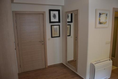 a bathroom with a mirror next to a toilet at Apartmani Art Karampana in Kotor