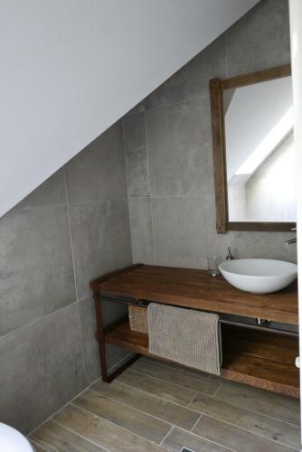 a bathroom with a sink and a mirror at Hillside Apartments in Révfülöp