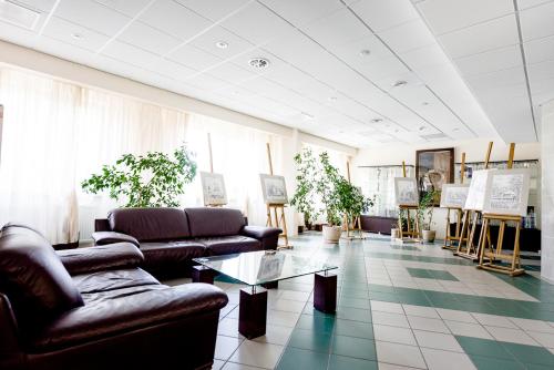 a living room with couches and a table at Hotel Stal in Stalowa Wola