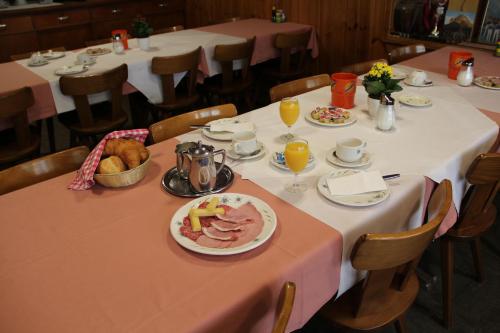 a table with a plate of food on it at Hotel-Restaurant Alpina in Innertkirchen