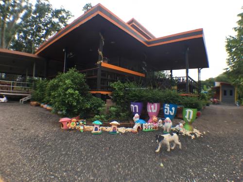 a group of toys in front of a building at Rai Eingpu in Ban Ta Khun