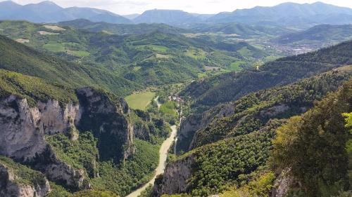 a view of a mountain valley with a dirt road at B&B Aquilegia in Acqualagna
