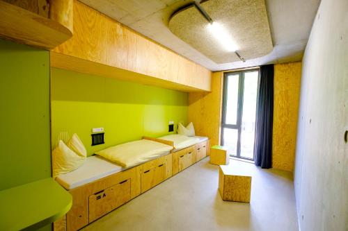 a room with two beds and a window at Jugendherberge Bayreuth in Bayreuth