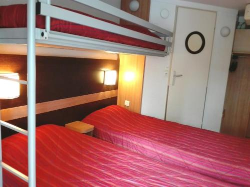 a bedroom with two bunk beds on a boat at Premiere Classe Grenoble Sud - Gieres Universite in Gières