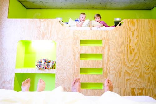 a man and a child laying in a bed at Jugendherberge Bayreuth in Bayreuth
