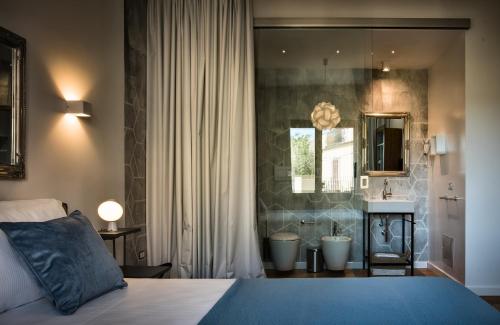 Cama o camas de una habitación en Teku Sardinia Boutique Hotel