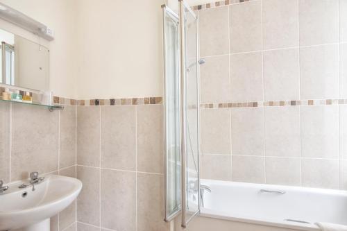 a bathroom with a shower and a sink at Luccombe Hall Hotel in Shanklin