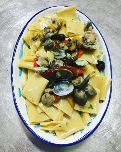 a plate of cheese and clams on a table at Albergo Villa Mario in Ischia