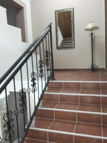 a staircase in a house with a mirror on the wall at Apartmani Radulović in Vrnjačka Banja