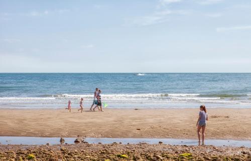 a group of people walking on the beach at Luccombe Manor Country House Hotel in Shanklin