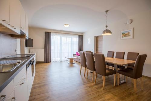 a kitchen and dining room with a table and chairs at Aparthotel Pichler in Flachau