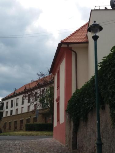 a building with a street light next to a building at Villa Magdalena in Kutná Hora