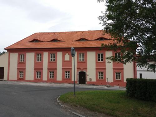 a large red and white building with a red roof at Villa Magdalena in Kutná Hora