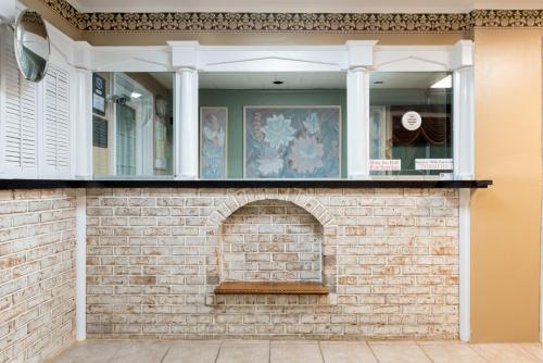 a brick wall with a window on top of it at Knights Inn Palmyra in Palmyra
