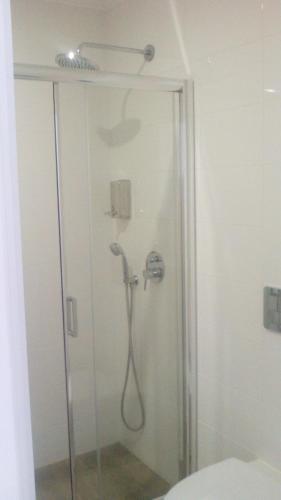 a shower with a shower head in a bathroom at Pico Dreams in São Roque do Pico